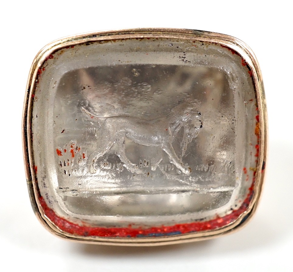 A 19th century gold plated and rock crystal? set fob seal, the matrix carved with hunting dog carrying prey, 24mm.